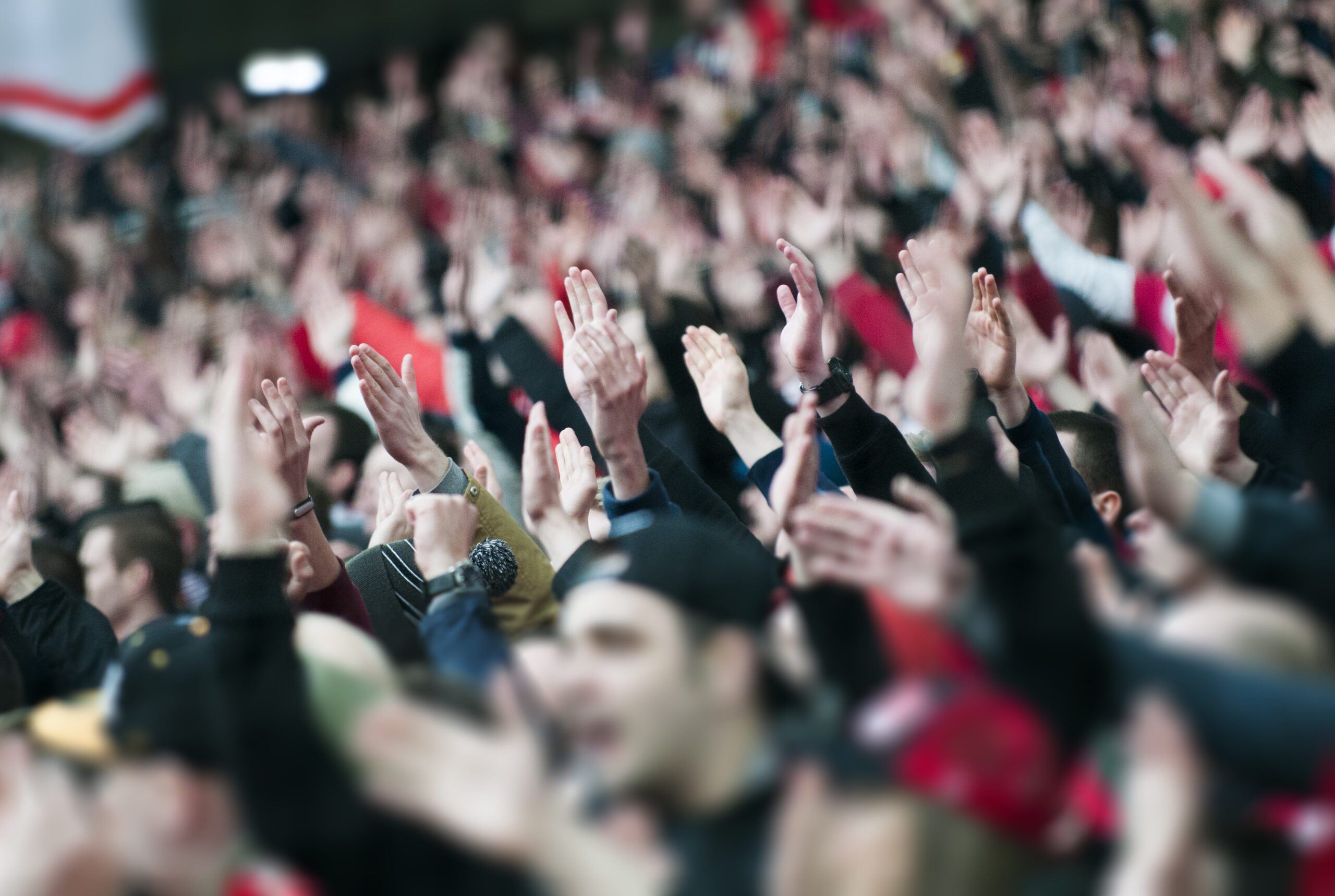 Crowd raising their hands in support of their favorite student athlete